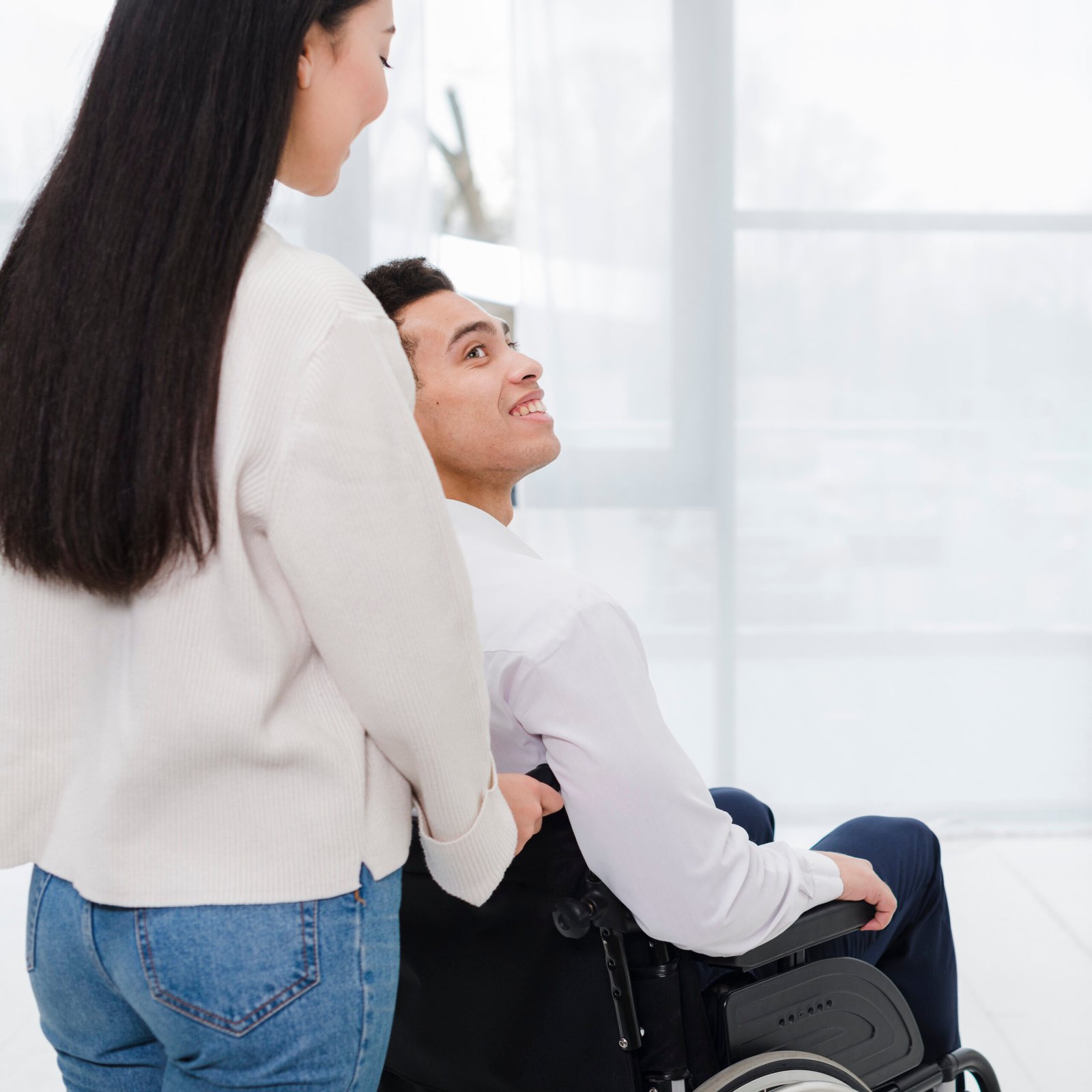close-up-woman-helping-disabled-woman-wheelchair